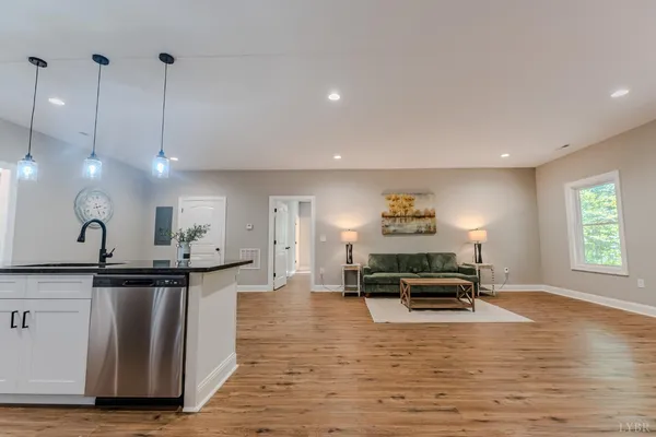 a living room with furniture and a wooden floor
