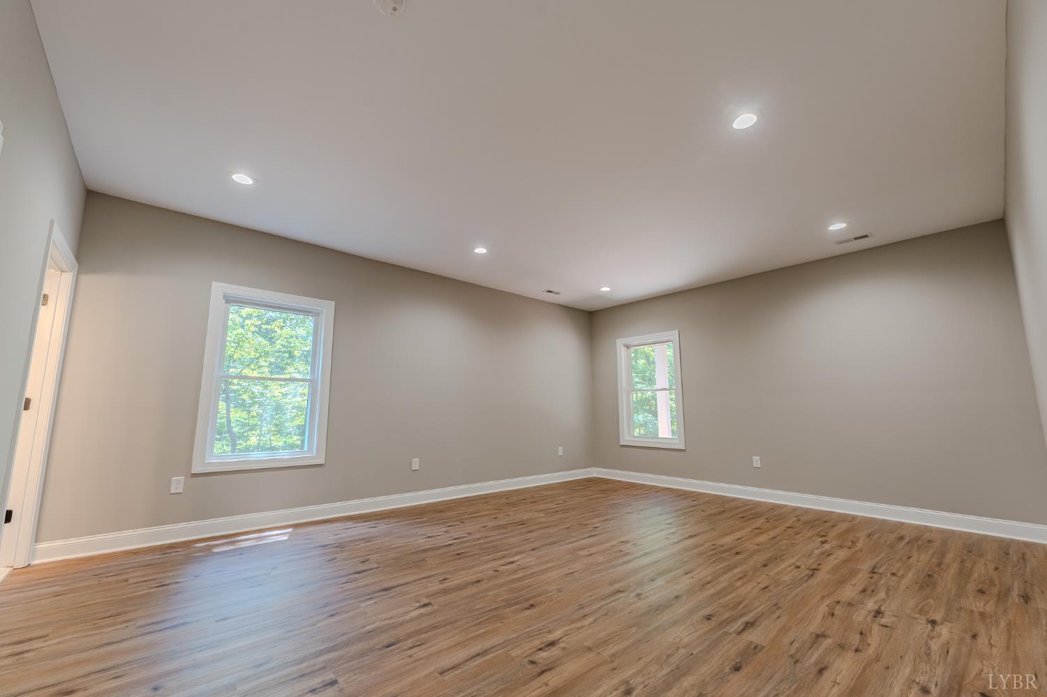 109 Tosh Lane Goodview, VA 24095 - Photo 15 of 32 a view of an empty room with wooden floor and a window