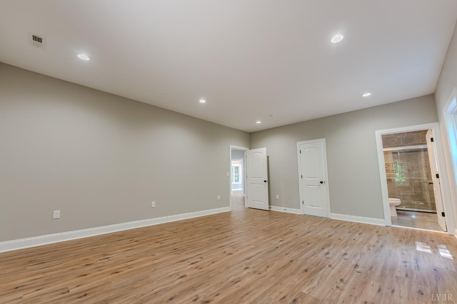 109 Tosh Lane Goodview, VA 24095 - Photo 16 of 32 a view of an empty room with wooden floor