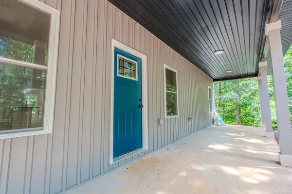 a view of a house with a big yard and large window