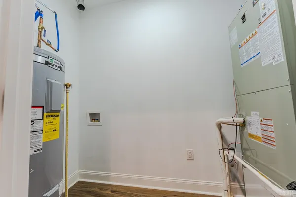 a living room with furniture a large window and stainless steel appliances