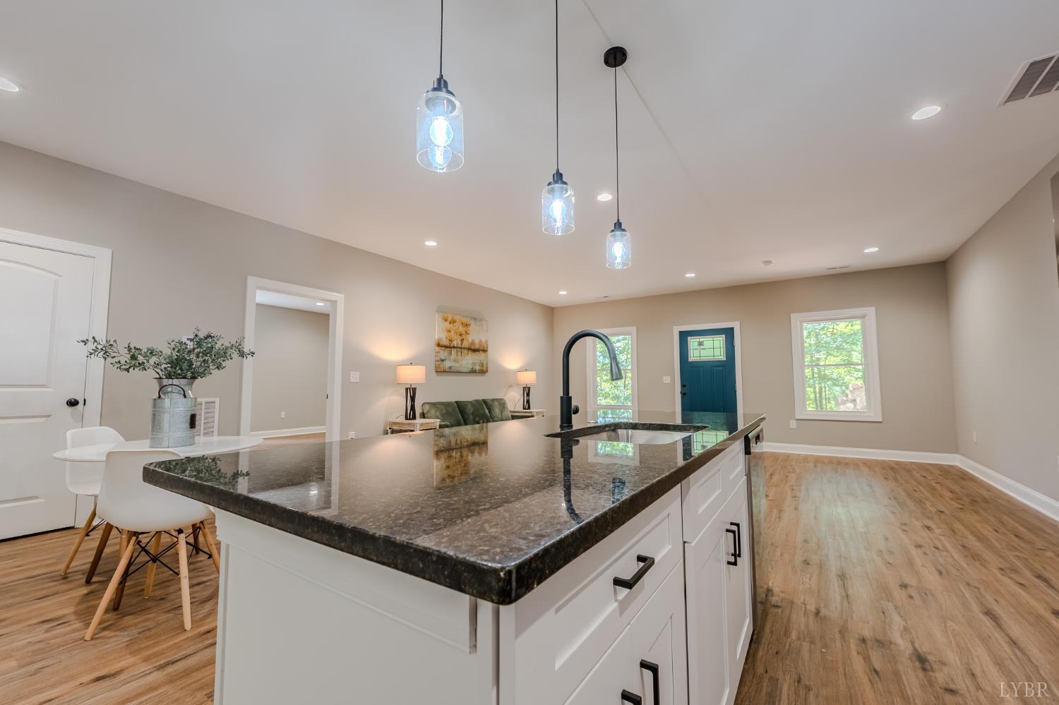 109 Tosh Lane Goodview, VA 24095 - Photo 30 of 32 a kitchen with granite countertop living room and living room