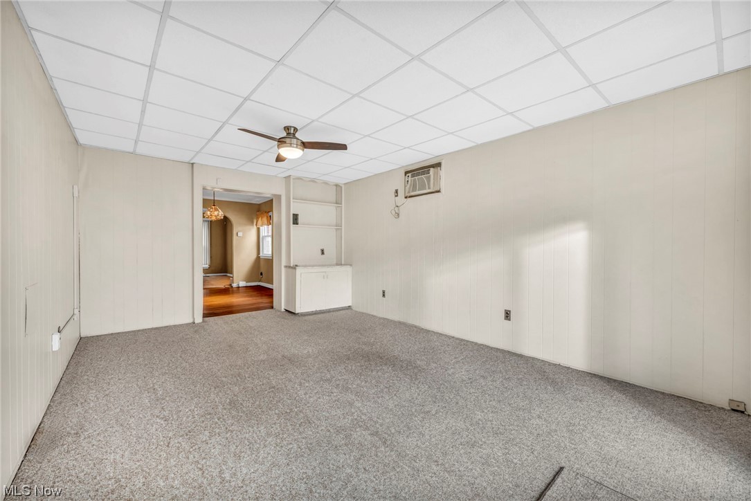 3946 Lansdale Road Cleveland, OH 44118 - Photo 25 of 42 Family room with a wall mounted AC, ceiling fan, and a paneled ceiling