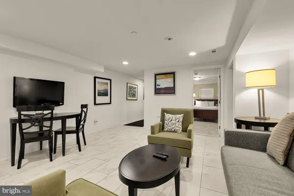 a bedroom with a bed and a potted plant on dresser