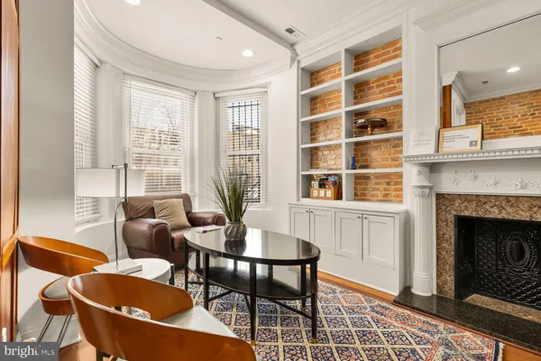 a dining room with furniture and a fireplace