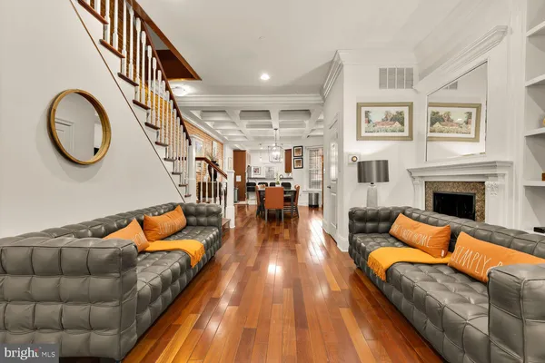 a living room with furniture a fireplace and a floor to ceiling window