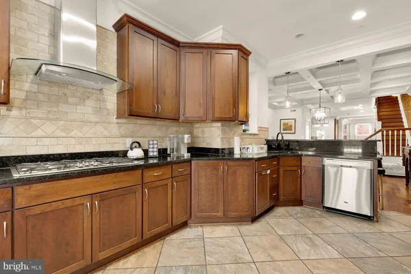 a kitchen with stainless steel appliances granite countertop a sink stove and cabinets