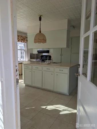 a kitchen with a sink stainless steel appliances and cabinets