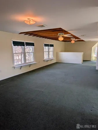 a view of an empty room with windows