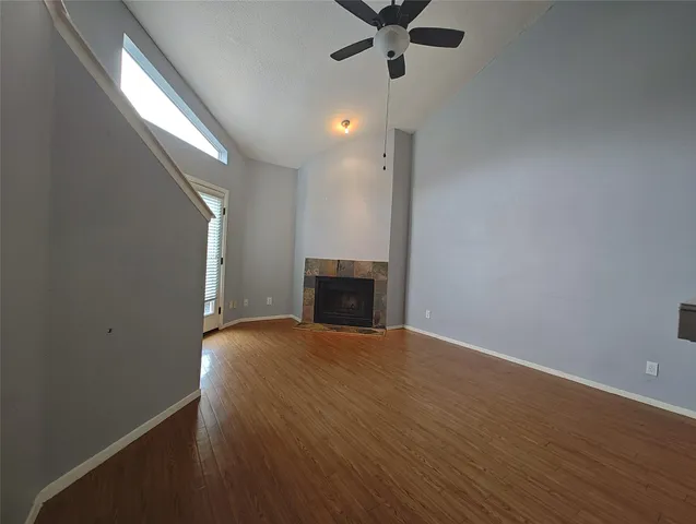an empty room with a empty space and chandelier fan