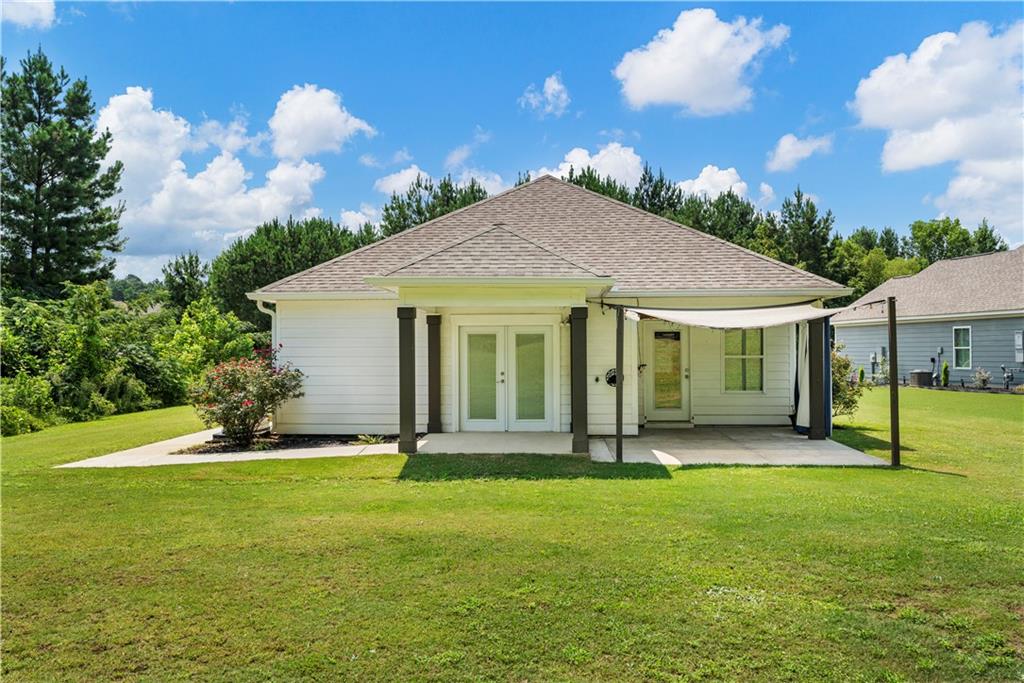 690 Bush Creek Road Opelika, AL 36804 - Photo 25 of 31 Rear exterior with white siding and a light-colored roof
