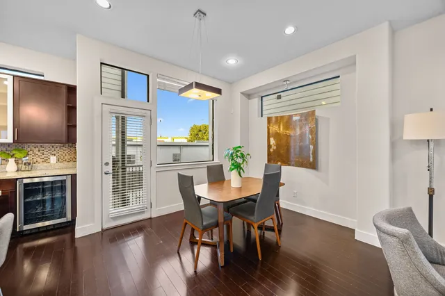 a view of a dining room with furniture window and wooden floor