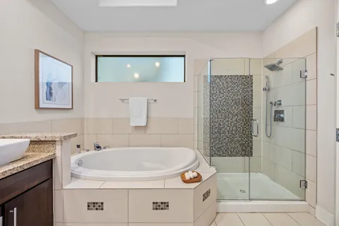 a bathroom with a granite countertop sink a mirror and a toilet