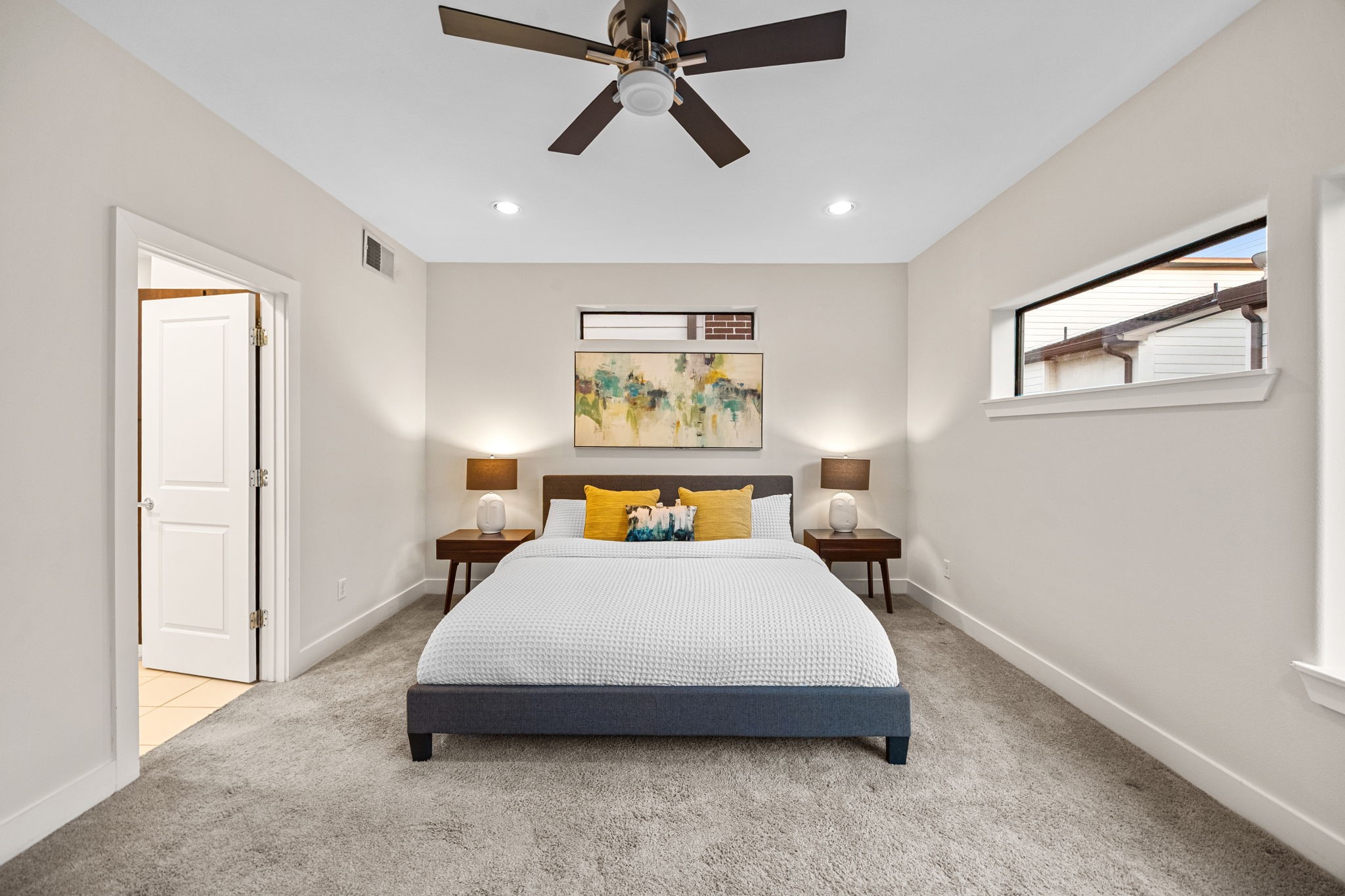 2005 Hickory Street Houston, TX 77007 - Photo 6 of 27 a bedroom with a bed a wall painting and a window