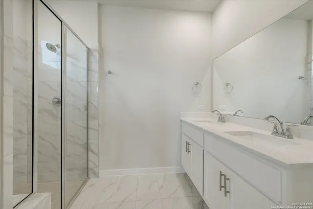 a bathroom with a double vanity sink and mirror