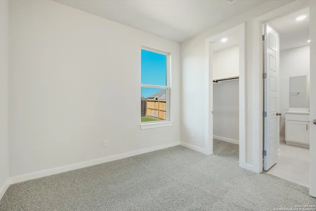 an empty room with a bathroom and a sink