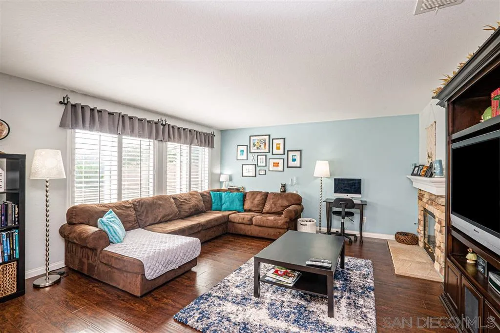300 River Ranch Way Oceanside, CA 92057 - Photo 5 of 25 a living room with furniture a flat screen tv and a window