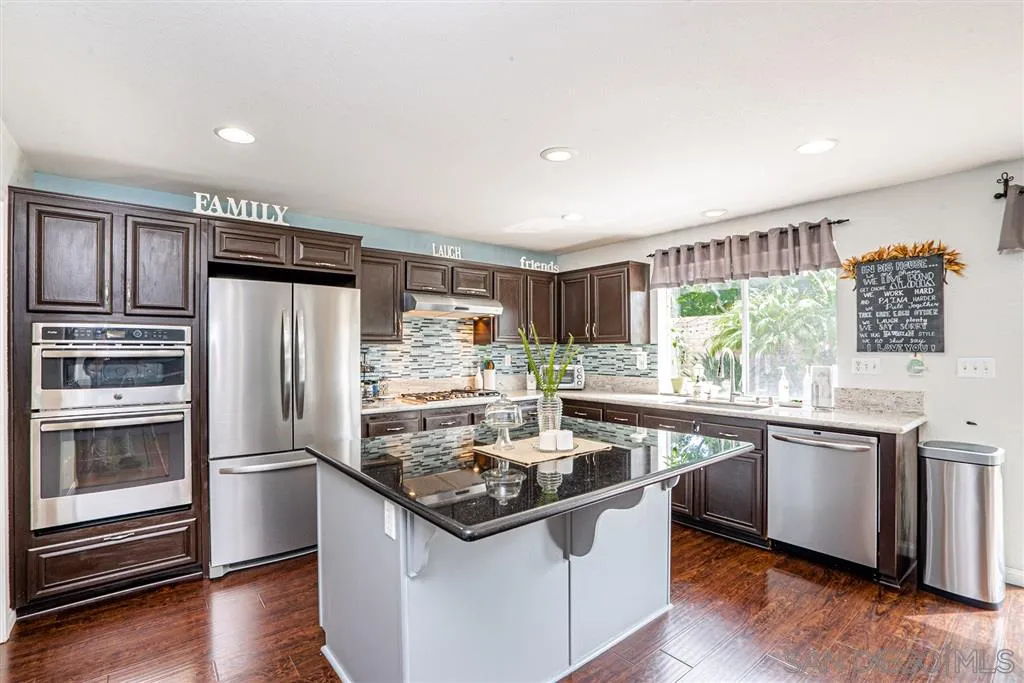 300 River Ranch Way Oceanside, CA 92057 - Photo 7 of 25 a kitchen with stainless steel appliances granite countertop a sink stove and refrigerator