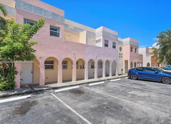a front view of a building with parking space