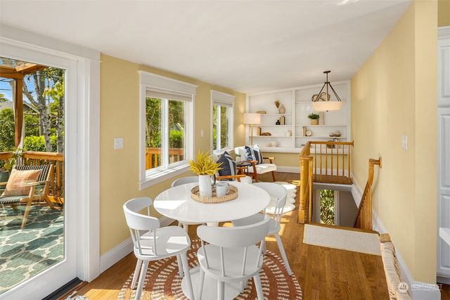 a dining room with furniture and wooden floor