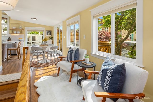 a living room with furniture and a floor to ceiling window