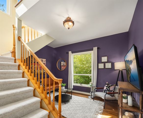 a view of staircase with furniture and a window