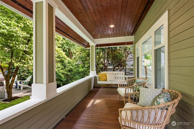 a balcony with furniture and wooden floor