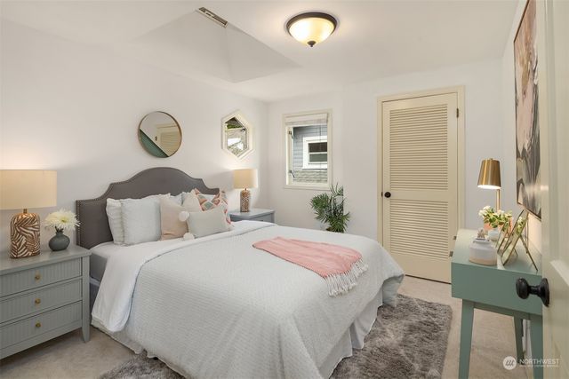 a bedroom with a bed and chandelier