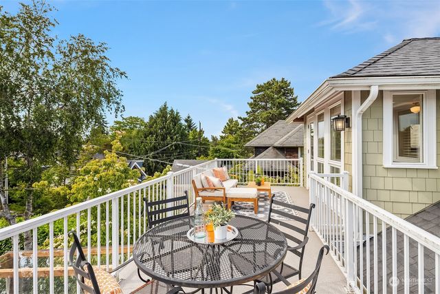 a view of a chair and tables in the balcony