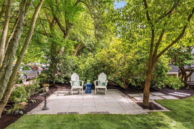 a view of a backyard with sitting area