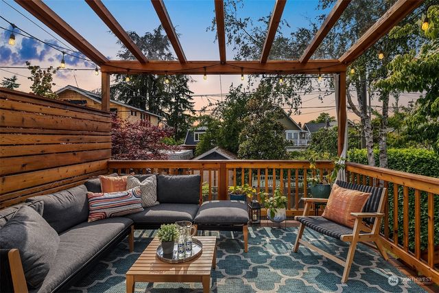 a roof deck with couches and wooden floor