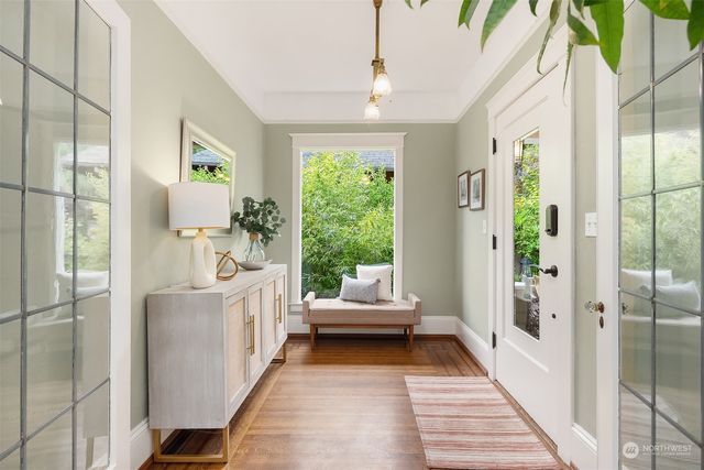 a view of a hallway to a livingroom with furniture