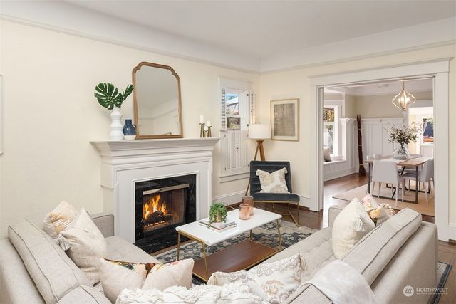 a living room with furniture a fireplace and a potted plant