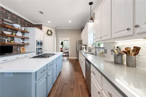 a kitchen with counter top space a sink and appliances