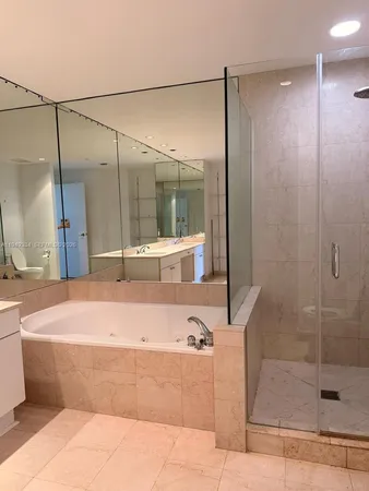 a bathroom with a bathtub and a shower