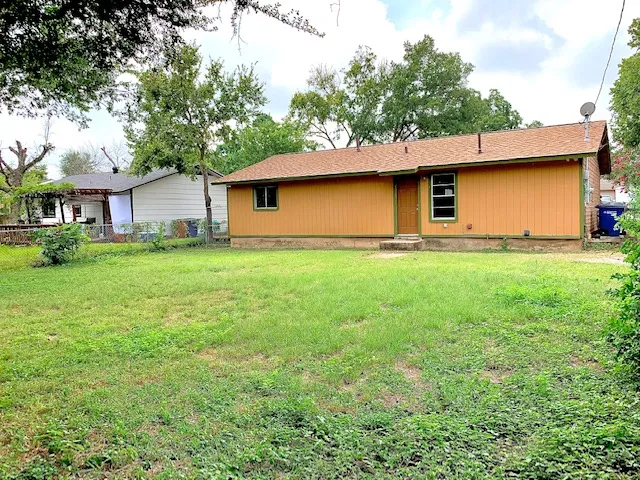 a house that has a tree in front of it