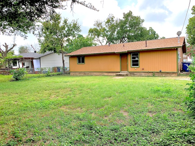 6114 Hogan Avenue Austin, TX 78741 - Photo 2 of 16 a house that has a tree in front of it