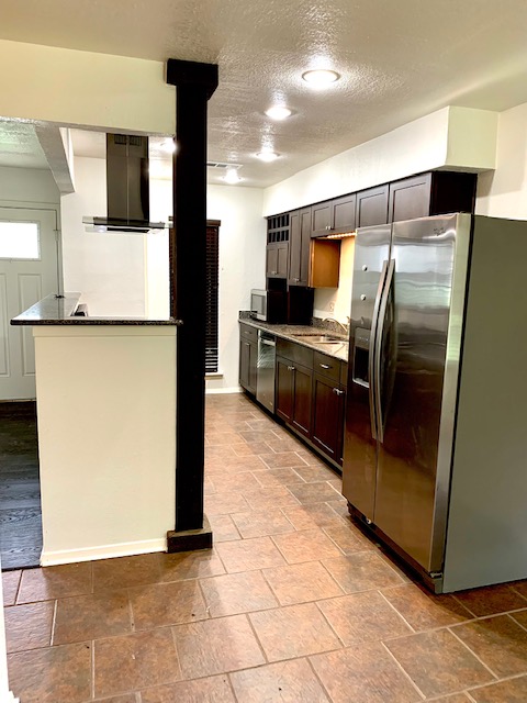 6114 Hogan Avenue Austin, TX 78741 - Photo 7 of 16 a kitchen with stainless steel appliances granite countertop a refrigerator and a stove