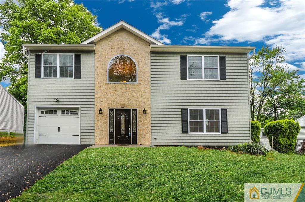 64 Winthrop Road Edison, NJ 08817 - Photo 1 of 24 a view of a house with a yard and garage