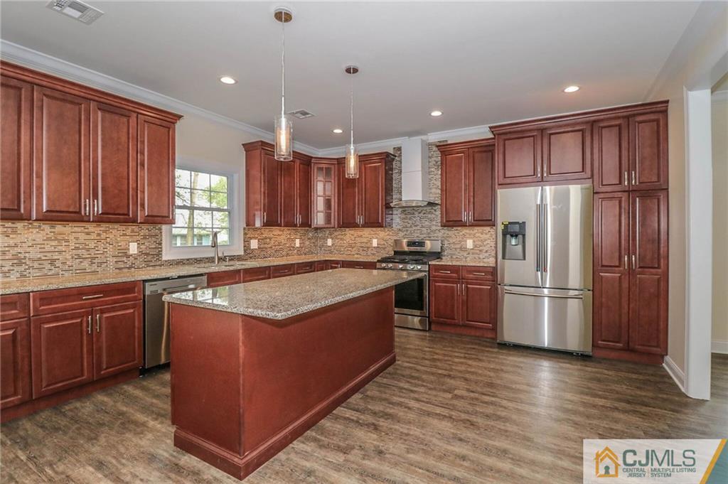 64 Winthrop Road Edison, NJ 08817 - Photo 12 of 24 a kitchen with stainless steel appliances granite countertop a stove a sink dishwasher a refrigerator and a oven