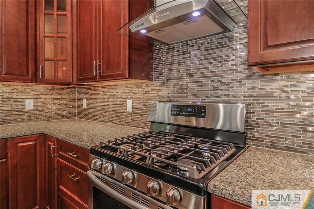 64 Winthrop Road Edison, NJ 08817 - Photo 15 of 24 a stove top oven sitting inside of a kitchen