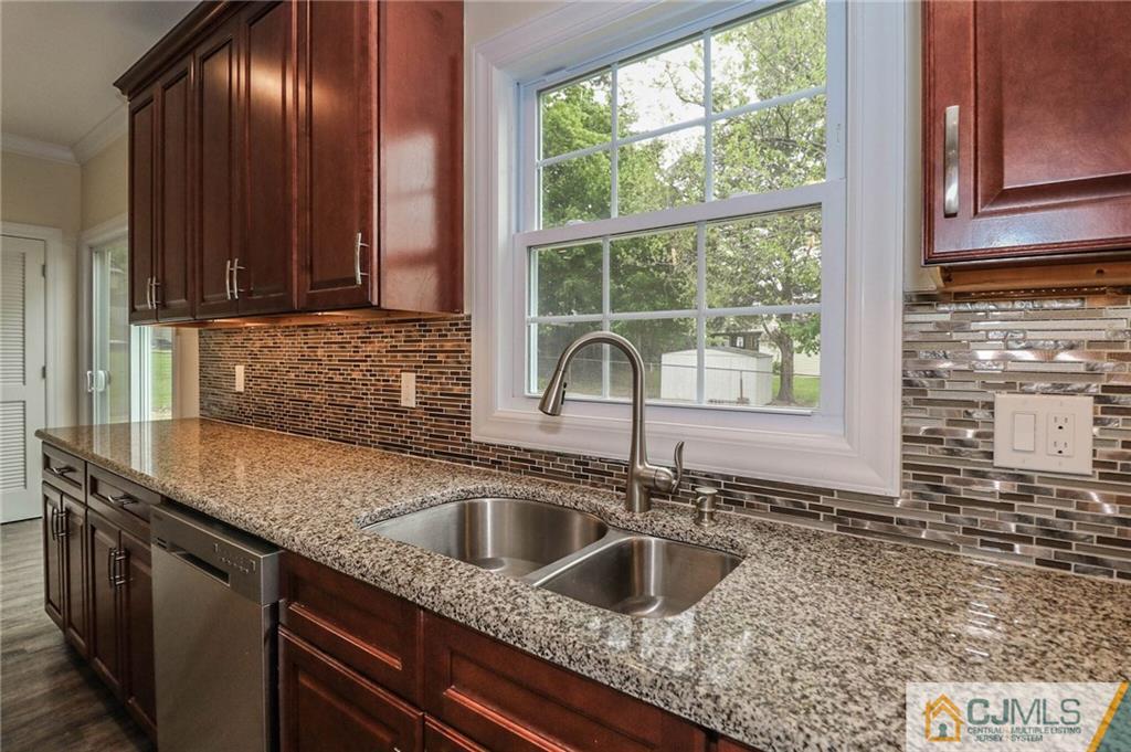 64 Winthrop Road Edison, NJ 08817 - Photo 16 of 24 a kitchen with granite countertop a sink and a window