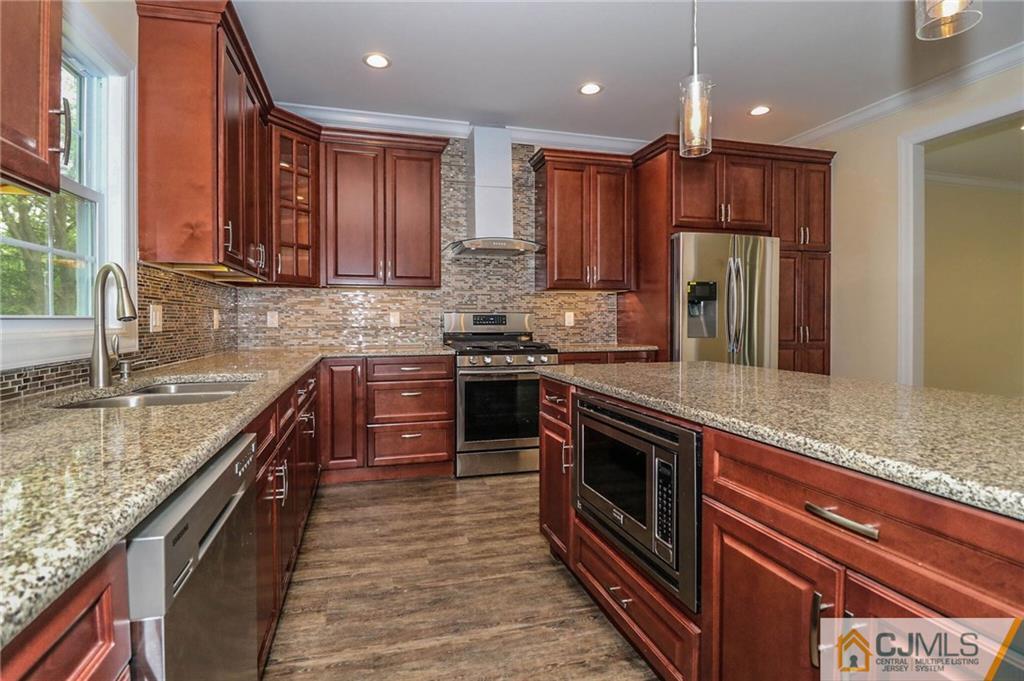 64 Winthrop Road Edison, NJ 08817 - Photo 17 of 24 a kitchen with stainless steel appliances granite countertop a sink stove and refrigerator