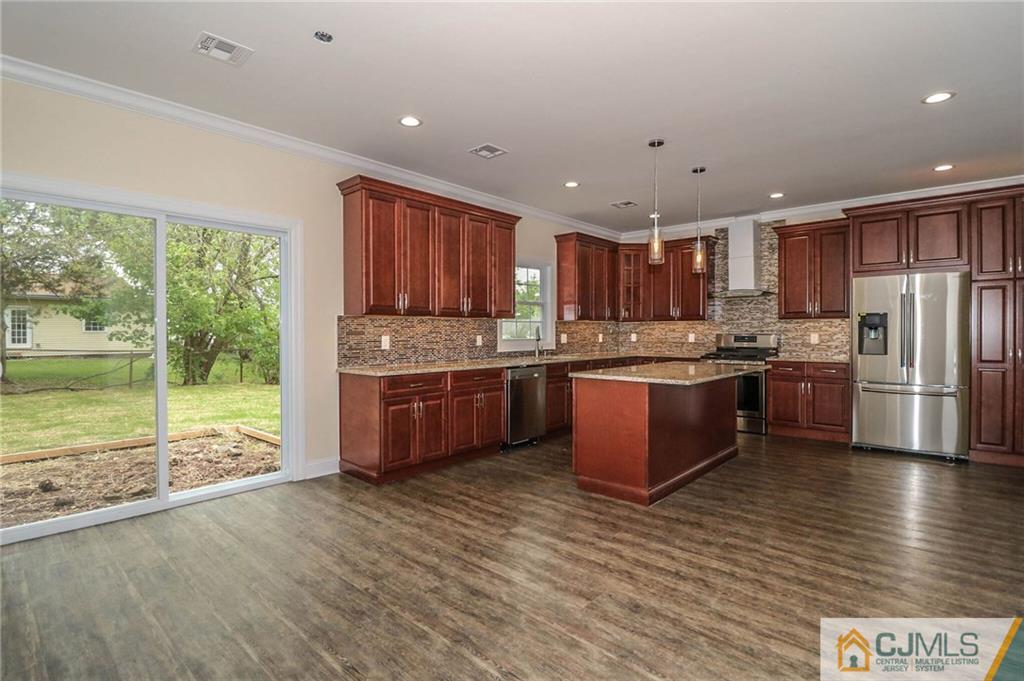 64 Winthrop Road Edison, NJ 08817 - Photo 18 of 24 a kitchen with stainless steel appliances granite countertop a stove a sink dishwasher a refrigerator and a oven with wooden floor