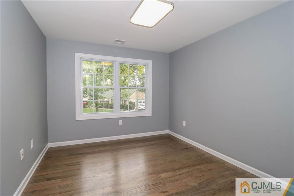 64 Winthrop Road Edison, NJ 08817 - Photo 20 of 24 an empty room with wooden floor and windows