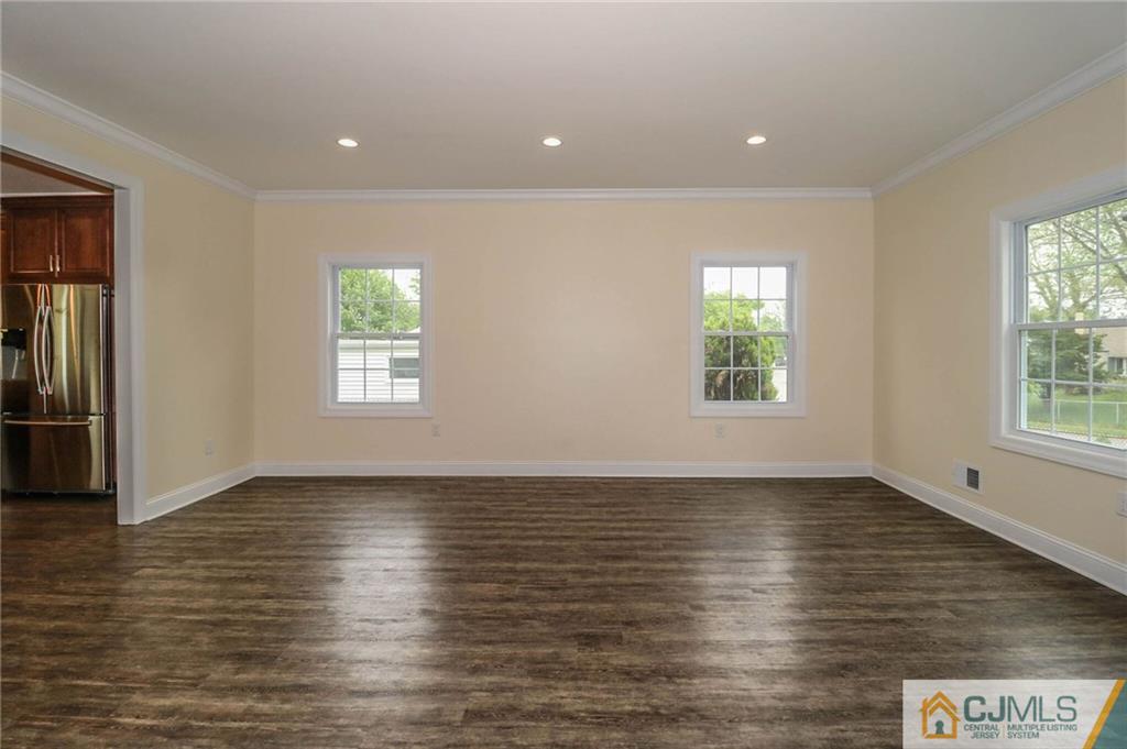 64 Winthrop Road Edison, NJ 08817 - Photo 22 of 24 an empty room with wooden floor and windows