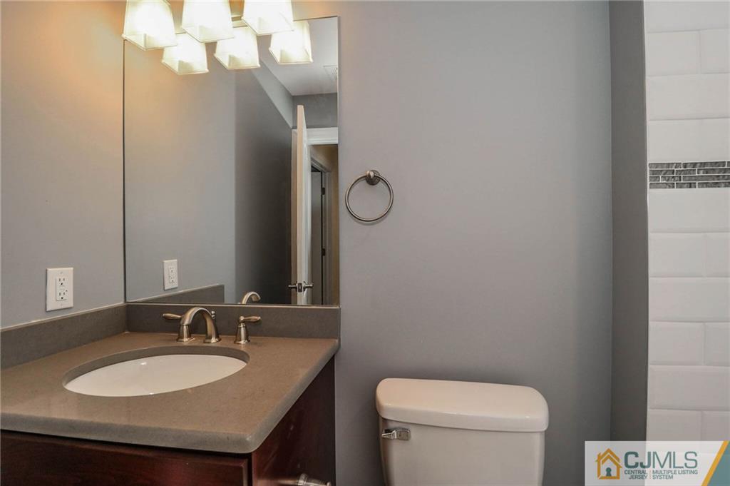64 Winthrop Road Edison, NJ 08817 - Photo 24 of 24 a bathroom with a granite countertop sink a toilet and a mirror