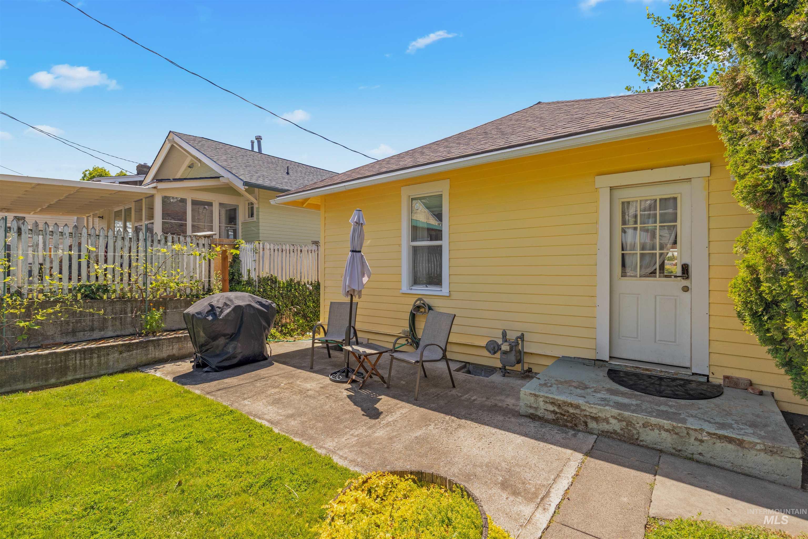 619 Prospect Avenue Lewiston, ID 83501 - Photo 29 of 37 Yellow siding exterior featuring white trim windows and a white paneled door