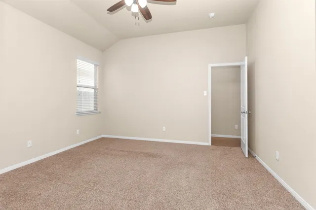 an empty room with a empty space and a ceiling fan