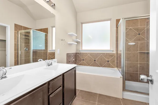 a bathroom with a tub sink and mirror